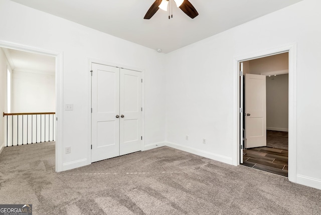 unfurnished bedroom featuring carpet, a closet, and ceiling fan
