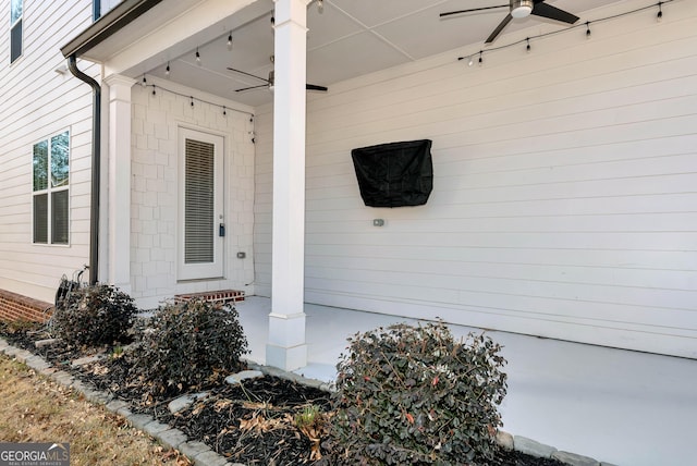 view of exterior entry featuring ceiling fan