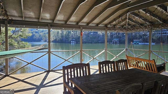 unfurnished sunroom with a water view