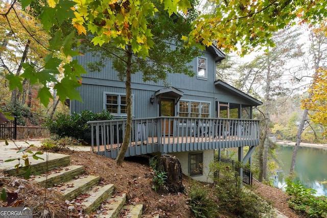 rear view of property with a deck with water view