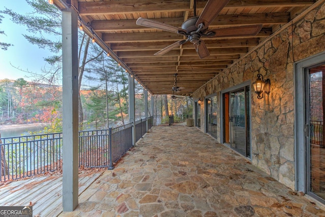 view of patio / terrace featuring ceiling fan and a water view