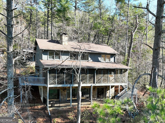 rear view of property with a sunroom