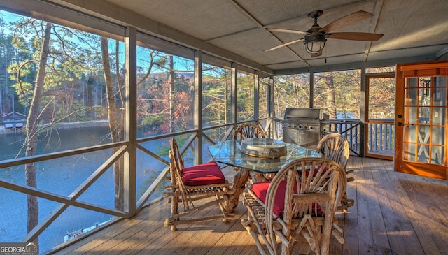 unfurnished sunroom with ceiling fan