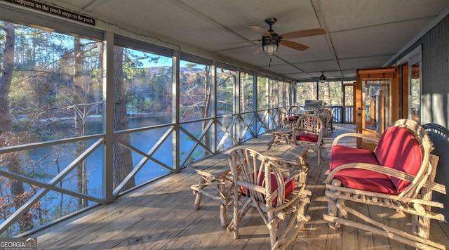 unfurnished sunroom featuring ceiling fan