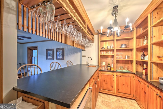 kitchen featuring ceiling fan with notable chandelier, ornamental molding, and sink