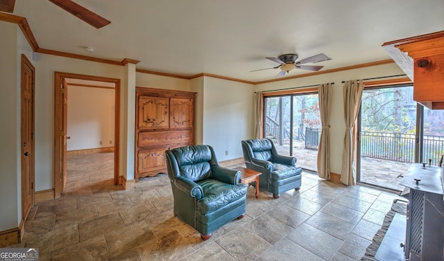 living area featuring ceiling fan and crown molding