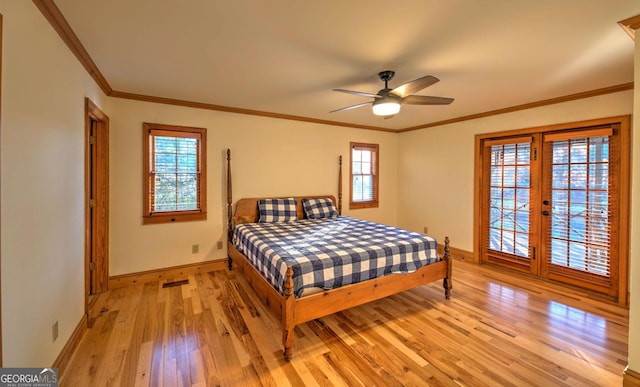 bedroom featuring ceiling fan, light hardwood / wood-style floors, and multiple windows