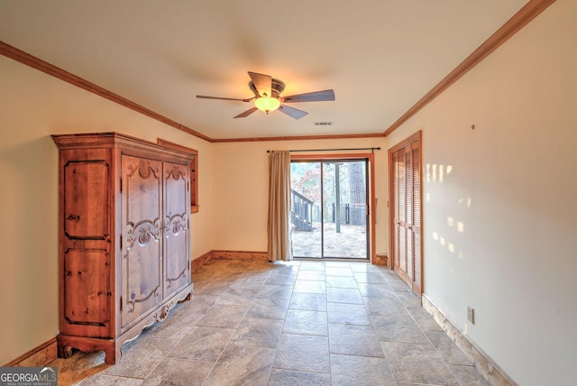 interior space featuring ceiling fan and crown molding