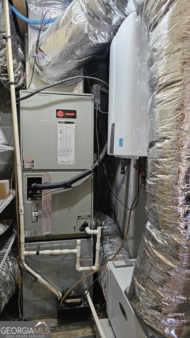 utility room featuring water heater