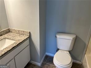 bathroom featuring vanity and toilet