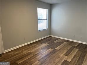 empty room featuring dark hardwood / wood-style flooring