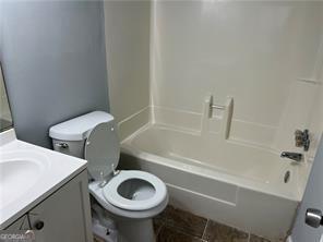 full bathroom featuring vanity, toilet, and bathing tub / shower combination