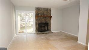 unfurnished living room with a stone fireplace