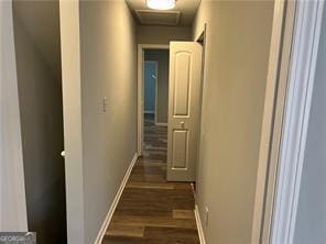 corridor with dark wood-type flooring