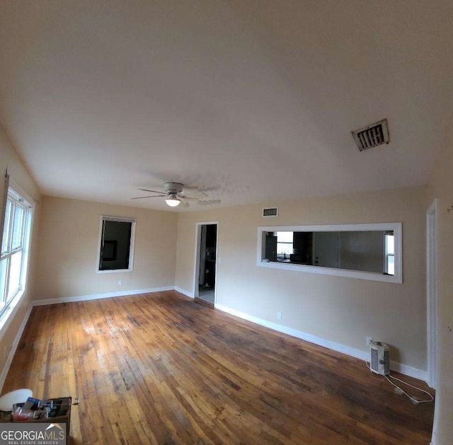 empty room with ceiling fan and hardwood / wood-style floors