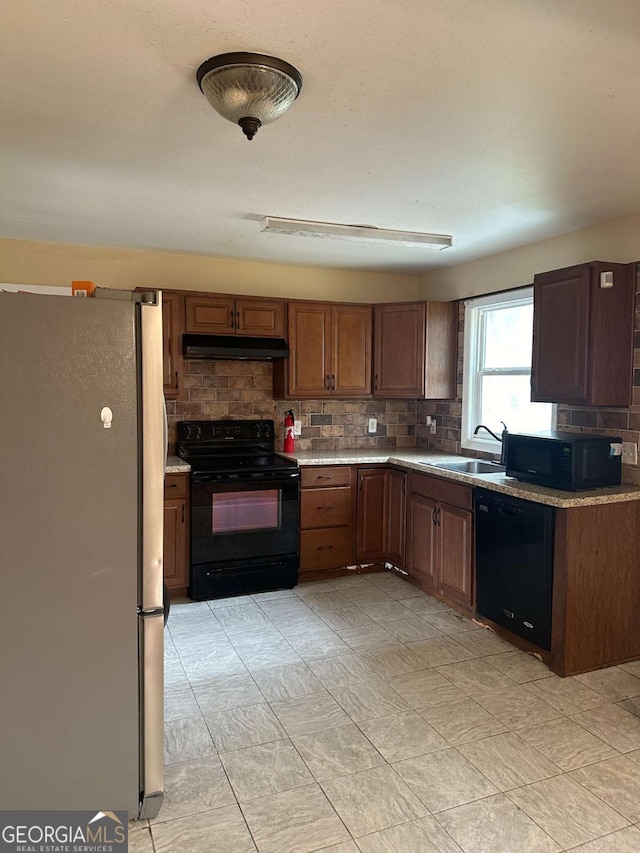 kitchen with tasteful backsplash, sink, and black appliances