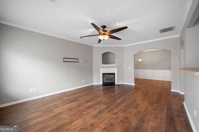 unfurnished living room featuring ceiling fan with notable chandelier, a textured ceiling, dark hardwood / wood-style flooring, and crown molding