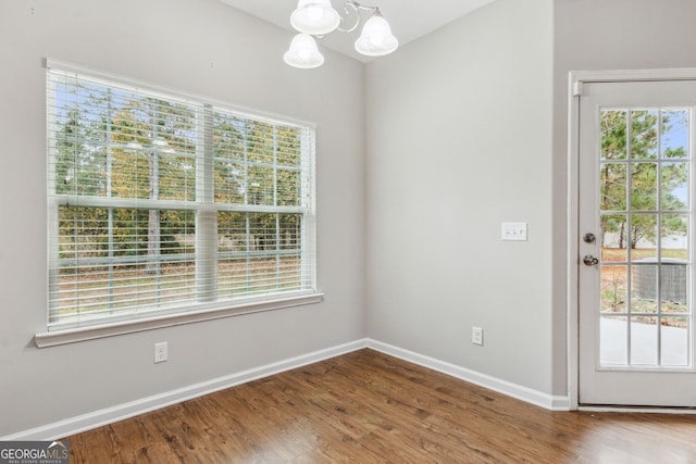 interior space with hardwood / wood-style flooring and an inviting chandelier