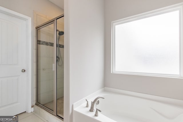 bathroom featuring tile patterned flooring and plus walk in shower