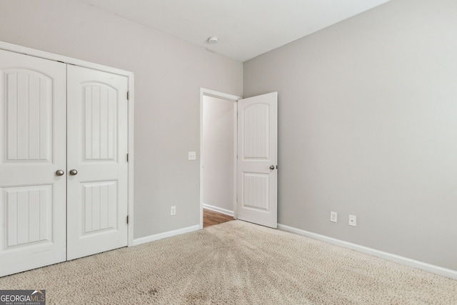 unfurnished bedroom with carpet and a closet