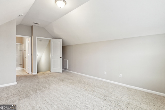 additional living space with light carpet and lofted ceiling