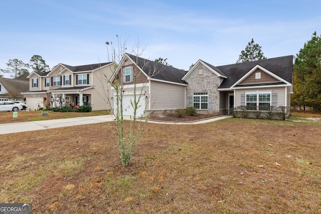 view of front of home featuring a front yard and a garage