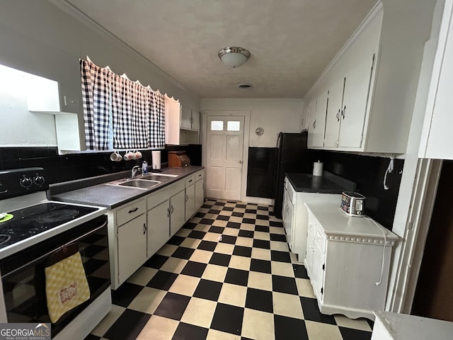 kitchen featuring white cabinets, white range with electric stovetop, and sink