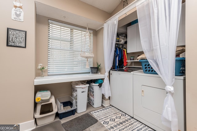 washroom with separate washer and dryer and cabinet space