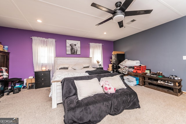 bedroom with carpet, visible vents, ceiling fan, and multiple windows