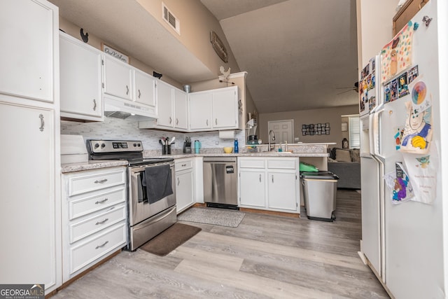 kitchen featuring visible vents, appliances with stainless steel finishes, light countertops, under cabinet range hood, and a sink