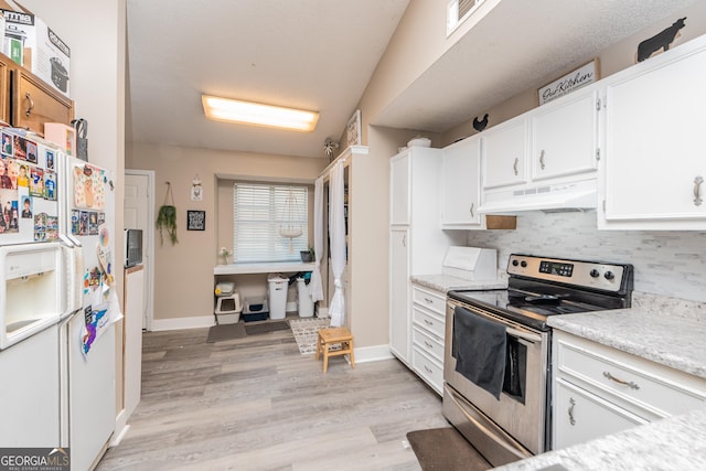 kitchen featuring white refrigerator with ice dispenser, white cabinets, stainless steel electric range, light countertops, and under cabinet range hood