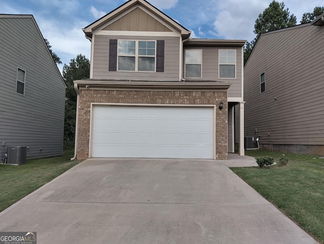 view of front of house with cooling unit, a front yard, and a garage