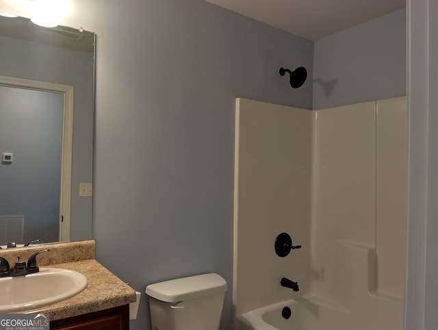 full bathroom featuring vanity, toilet, and washtub / shower combination