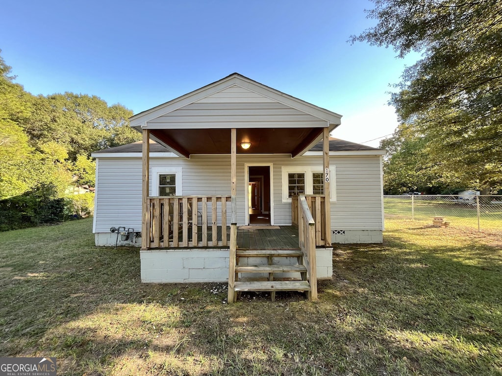 rear view of property with a yard