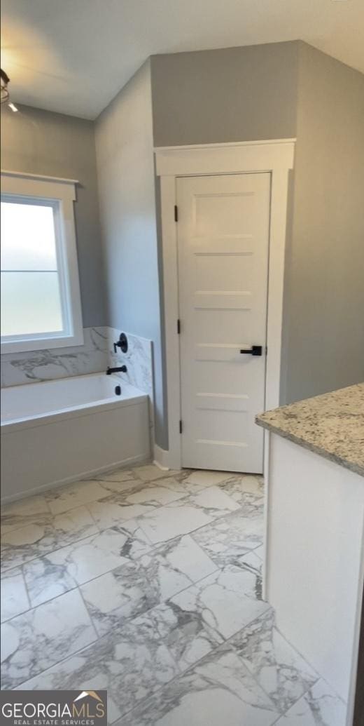 bathroom with a bathtub and vanity