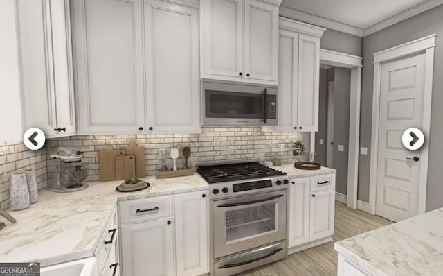 1950 Payne Rd, Rentz, GA 31075 - kitchen with stainless steel appliances, light wood-style floors, tasteful backsplash, white cabinetry, and ornamental molding