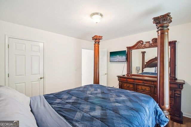 bedroom with hardwood / wood-style floors