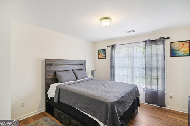 bedroom with hardwood / wood-style floors