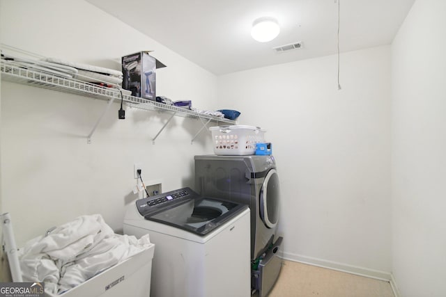 clothes washing area with independent washer and dryer