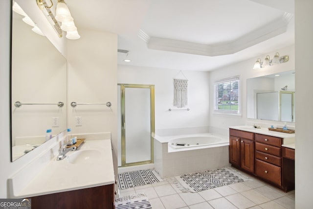 bathroom with a raised ceiling, tile patterned floors, vanity, and separate shower and tub