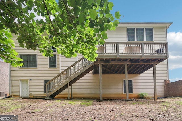 rear view of property with a deck and central AC unit