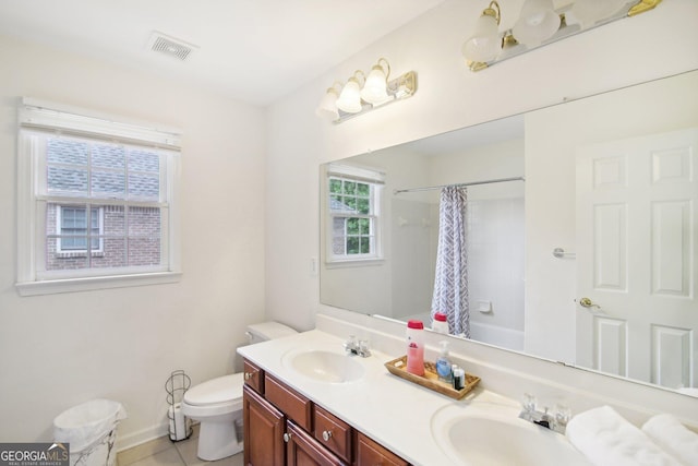 full bathroom with tile patterned flooring, plenty of natural light, vanity, and shower / tub combo