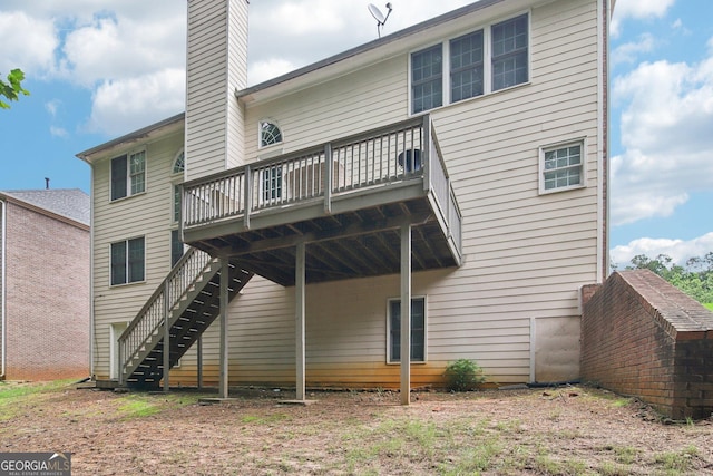 back of house with a wooden deck