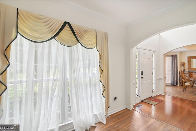 entryway featuring hardwood / wood-style floors and crown molding