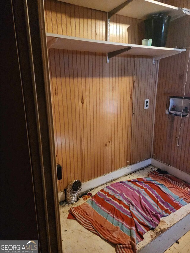 laundry room with washer hookup and wooden walls