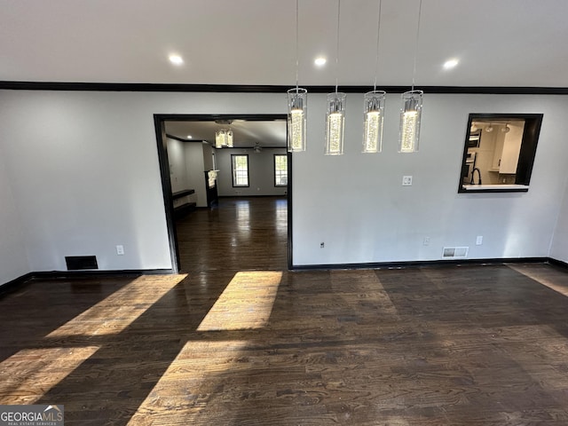 unfurnished room featuring dark hardwood / wood-style flooring, ceiling fan, and ornamental molding