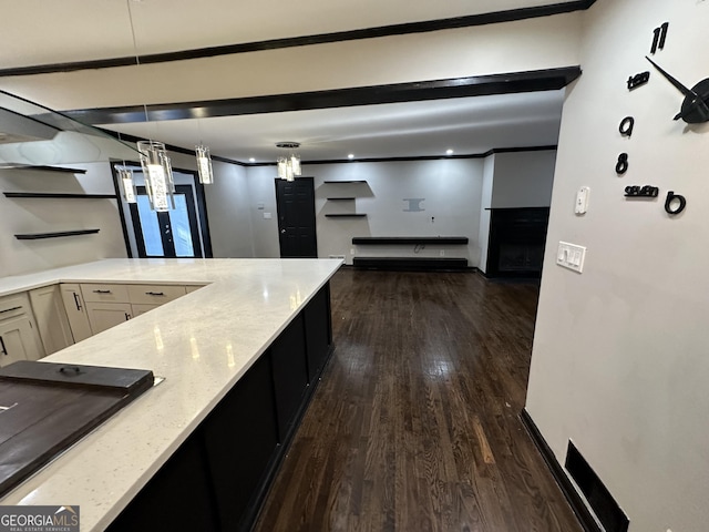 kitchen with dark hardwood / wood-style flooring, light stone counters, white cabinetry, and hanging light fixtures