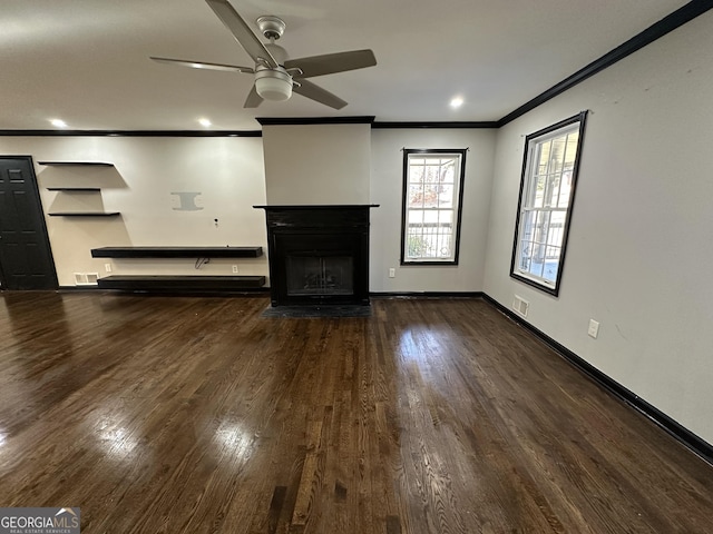 unfurnished living room with ceiling fan, dark hardwood / wood-style flooring, and ornamental molding