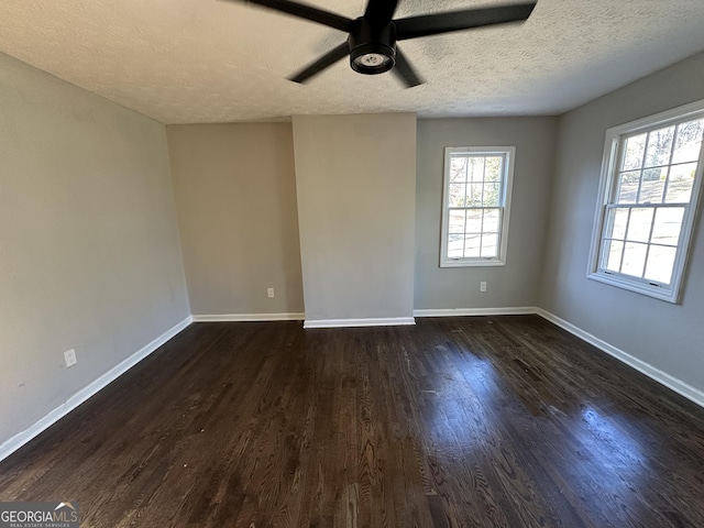 spare room with dark hardwood / wood-style floors, ceiling fan, and a textured ceiling