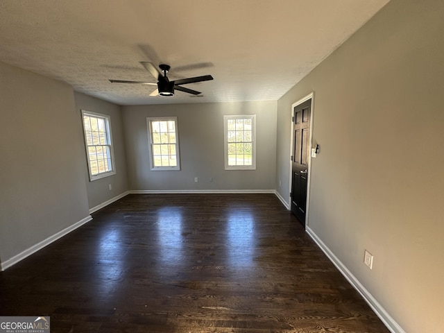 unfurnished room featuring ceiling fan and dark wood-type flooring